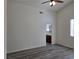 Spacious primary bedroom with wood-look floors, ceiling fan and an en suite bathroom at 9463 Jumping Frog Ct, Las Vegas, NV 89147
