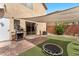 A cozy backyard featuring artificial turf, patio, shade and lush greenery for outdoor relaxation at 9737 Darlington Ct, Las Vegas, NV 89149