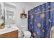 Bathroom featuring a toilet, sink, and a shower/tub combo with a blue patterned curtain at 9737 Darlington Ct, Las Vegas, NV 89149