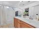 Bright bathroom featuring a double sink vanity, a tub, and a shower with a shower curtain at 9737 Darlington Ct, Las Vegas, NV 89149