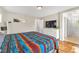 Bright primary bedroom with wood floors and adjacent bath, featuring a Southwestern-style blanket at 9737 Darlington Ct, Las Vegas, NV 89149