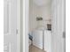 Laundry room with white washer and dryer, complemented by white walls and a door frame at 9737 Darlington Ct, Las Vegas, NV 89149
