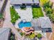 Beautiful aerial view of a luxury property showcasing a rock waterslide pool, lush landscaping, and covered patio area at 9920 Rancho Destino Rd, Las Vegas, NV 89183
