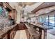 Long entertaining bar featuring a mosaic backsplash, luxury finishes and a stainless steel wine fridge at 9920 Rancho Destino Rd, Las Vegas, NV 89183