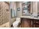 Modern bathroom with a tiled shower and a vanity with a decorative mirror at 9920 Rancho Destino Rd, Las Vegas, NV 89183