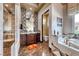 Luxurious bathroom featuring a walk-in shower, vanity, and adjacent soaking tub at 9920 Rancho Destino Rd, Las Vegas, NV 89183
