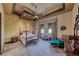 Bedroom featuring sitting area and four-poster bed with floral bedding at 9920 Rancho Destino Rd, Las Vegas, NV 89183