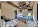 Comfortable bedroom featuring tray ceiling, two windows, and blue bedding at 9920 Rancho Destino Rd, Las Vegas, NV 89183