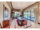 Formal dining room with elegant furnishings, natural light, and views of the landscaped backyard at 9920 Rancho Destino Rd, Las Vegas, NV 89183