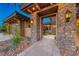 Stone archway leading to the front door with water feature at 9920 Rancho Destino Rd, Las Vegas, NV 89183
