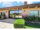 Exterior shot of home showcasing windows reflecting the lush backyard at 9920 Rancho Destino Rd, Las Vegas, NV 89183