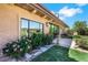 Exterior shot of home showcasing windows framed by colorful rose bushes at 9920 Rancho Destino Rd, Las Vegas, NV 89183