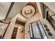 Magnificent foyer featuring a stunning chandelier, custom ceiling design, and elegant front door at 9920 Rancho Destino Rd, Las Vegas, NV 89183