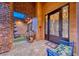 Ornate double front doors with sitting bench and water feature at 9920 Rancho Destino Rd, Las Vegas, NV 89183