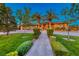 Well-manicured front yard and landscaping leading to front door at 9920 Rancho Destino Rd, Las Vegas, NV 89183