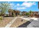 Charming guest house on a stone path with desert landscaping and nearby main house at 9920 Rancho Destino Rd, Las Vegas, NV 89183