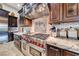 Well-equipped kitchen featuring a professional-grade range, custom cabinetry, and marble countertops at 9920 Rancho Destino Rd, Las Vegas, NV 89183
