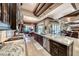 Open-concept kitchen with high-end appliances, a center island, and seamless flow to the dining and living areas at 9920 Rancho Destino Rd, Las Vegas, NV 89183