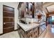 A gourmet kitchen featuring custom wood cabinetry, marble countertops, and high-end stainless steel appliances at 9920 Rancho Destino Rd, Las Vegas, NV 89183
