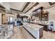 Gourmet kitchen featuring a large island, custom cabinetry, stainless steel appliances, and marble countertops at 9920 Rancho Destino Rd, Las Vegas, NV 89183