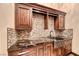 Luxurious laundry room with custom cabinets, mosaic backsplash, and granite countertops at 9920 Rancho Destino Rd, Las Vegas, NV 89183