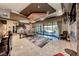 Open living area with patio access, comfortable seating, a large rug, and a stylishly decorated bar at 9920 Rancho Destino Rd, Las Vegas, NV 89183