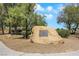 Park with a large engraved rock surrounded by trees, grass and a paved pathway at 9920 Rancho Destino Rd, Las Vegas, NV 89183