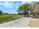 Expansive view of a green park with a gazebo, picnic tables, bike racks, and walking paths on a sunny day at 9920 Rancho Destino Rd, Las Vegas, NV 89183