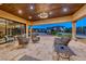Spacious covered patio with elegant furniture, travertine floors, and recessed lighting at 9920 Rancho Destino Rd, Las Vegas, NV 89183