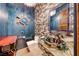 A unique powder room with an artistic sink, designer finishes and a decorative mirror at 9920 Rancho Destino Rd, Las Vegas, NV 89183