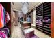 Spacious walk-in closet featuring custom shelves and a central island with drawers at 9920 Rancho Destino Rd, Las Vegas, NV 89183