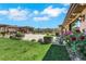 Expansive backyard with lush greenery, patio, and a glimpse of the pool at 9920 Rancho Destino Rd, Las Vegas, NV 89183