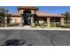 Community clubhouse with a tile roof, desert landscaping and ample parking at 7701 W Robindale Rd # 127, Las Vegas, NV 89113