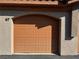 Neutral-toned garage door with a multi-panel design providing secure access to the home at 7701 W Robindale Rd # 127, Las Vegas, NV 89113