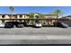 Covered parking area available for residents and guests with well-maintained landscaping and building facade at 7701 W Robindale Rd # 127, Las Vegas, NV 89113