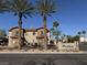 Community signage with tile roof and mature palm trees at 7701 W Robindale Rd # 127, Las Vegas, NV 89113
