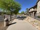 Paved walking path with mature trees and desert landscaping along side of building at 7701 W Robindale Rd # 127, Las Vegas, NV 89113
