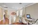 Entryway featuring hardwood floors, white staircase, a work area with seating and door to outside at , Las Vegas, NV 89148