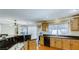 Spacious kitchen with wood cabinets, black granite countertops, dishwasher, and hardwood floors at , Las Vegas, NV 89148