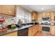 Well-equipped kitchen featuring wooden cabinets, granite countertops, and modern appliances at , Las Vegas, NV 89148
