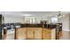 Open-concept kitchen with dark countertops, wood cabinets and hardwood floors throughout at , Las Vegas, NV 89148
