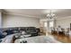 Open-concept living room featuring hardwood floors, a black leather sofa, and a dining area at , Las Vegas, NV 89148