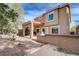 A spacious backyard with covered patio, gravel landscaping, and a view of the home's exterior at 11120 Whooping Crane Ln, Las Vegas, NV 89144