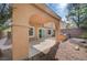 Covered patio and backyard featuring a built-in grill and mature landscaping at 11120 Whooping Crane Ln, Las Vegas, NV 89144