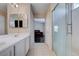 Modern bathroom featuring a double sink vanity and a glass shower with tile surround at 11120 Whooping Crane Ln, Las Vegas, NV 89144