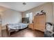 Cozy bedroom with wood floors, natural light, and ample space for a double bed and dresser at 11120 Whooping Crane Ln, Las Vegas, NV 89144