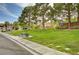 Community park with lush green space, mature trees, and picnic tables at 11120 Whooping Crane Ln, Las Vegas, NV 89144