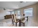 Bright dining area features a stylish table and chairs, tiled floors, and natural light from large windows at 11120 Whooping Crane Ln, Las Vegas, NV 89144