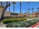 Fallbrook neighborhood entrance with lush landscaping and palm trees at 11120 Whooping Crane Ln, Las Vegas, NV 89144