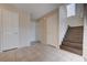 Inviting entryway featuring tile flooring, wooden stairs, and neutral wall tones at 11120 Whooping Crane Ln, Las Vegas, NV 89144